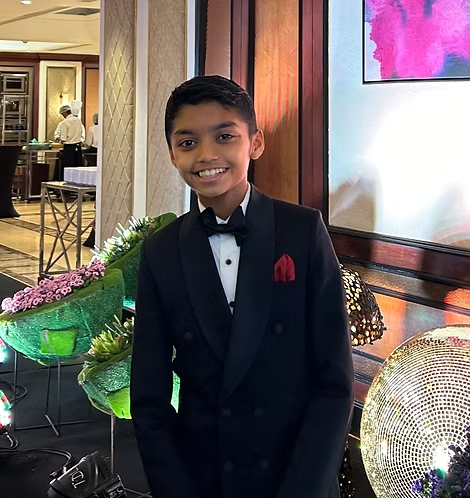 Founder of Earthquarter smiling in formal wear